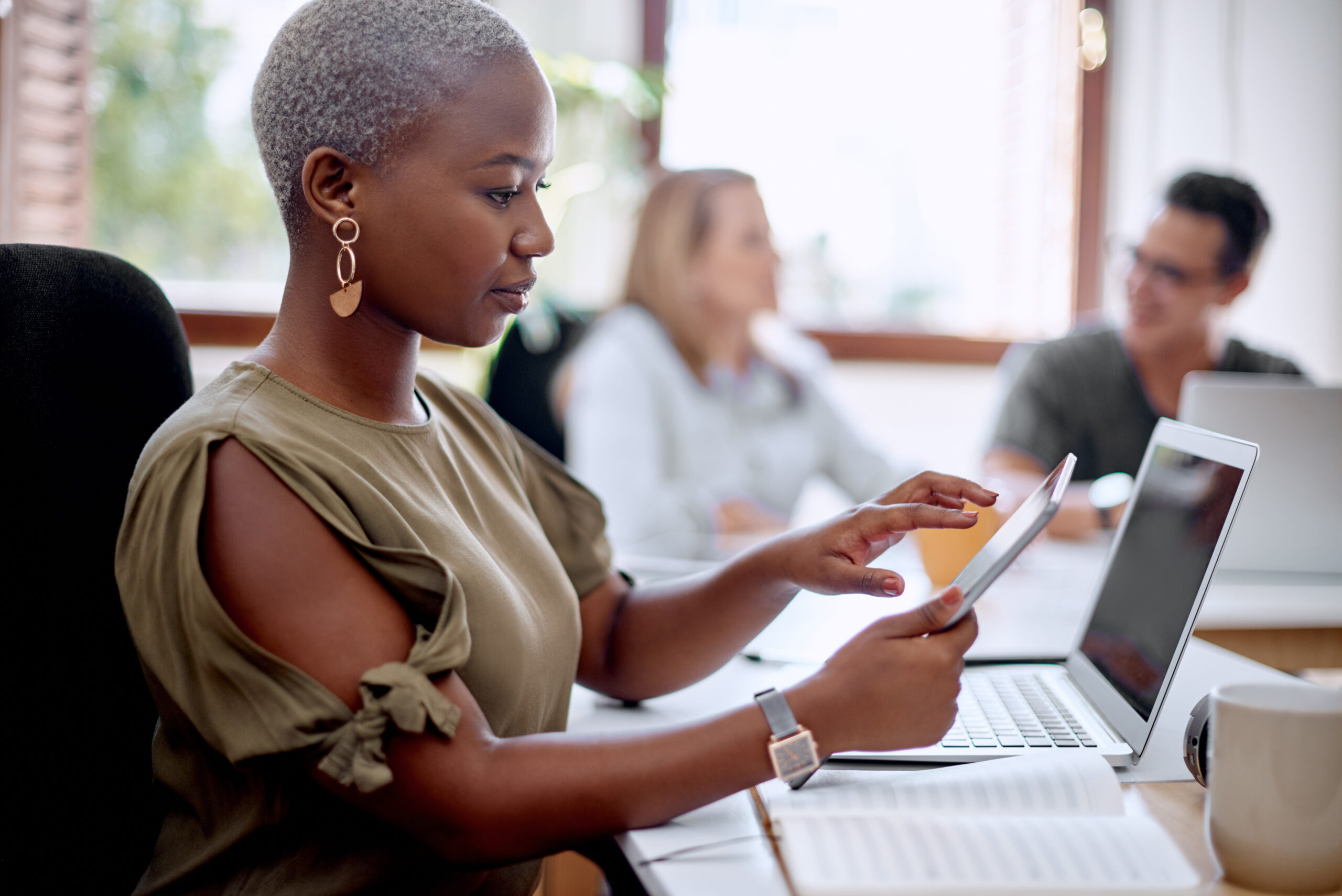 Working towards the best end results. a young businesswoman using a digital tablet in an office.